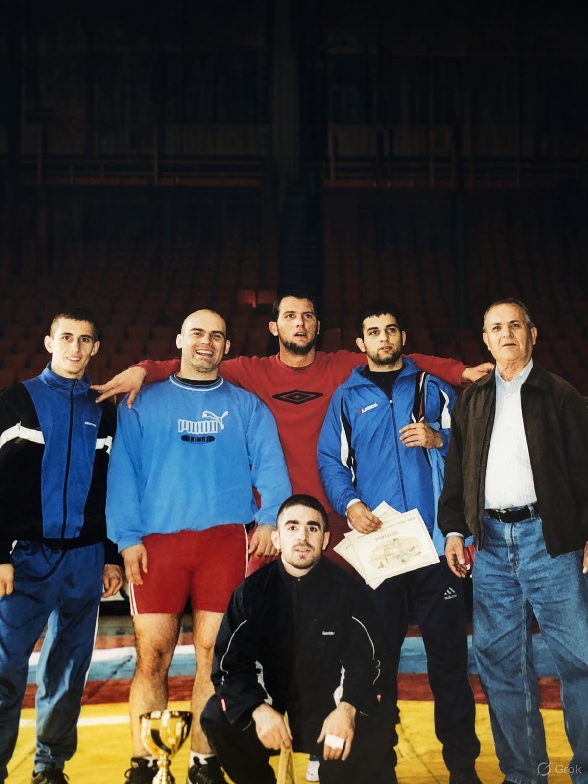 Rolen with fellow wrestlers and coaches after competition